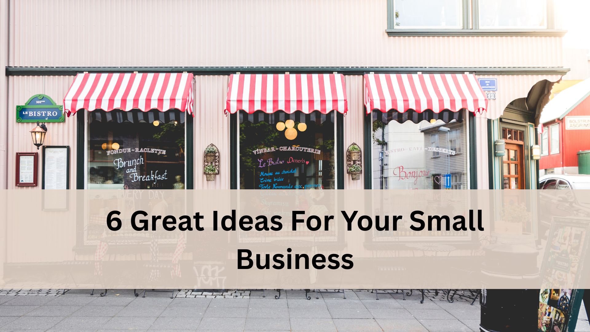 A small bistro storefront with red and white striped awnings over large windows that display brunch and dessert menus