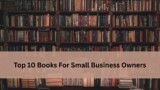 Bookshelf filled with rows of books with a soft beige banner across the center displaying the text 'Top 10 Books For Small Business Owners