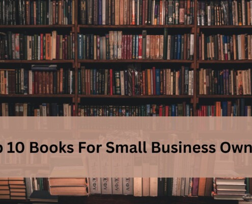 Bookshelf filled with rows of books with a soft beige banner across the center displaying the text 'Top 10 Books For Small Business Owners