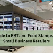 Grocery store aisle with large refrigerated cases filled with food items, with text overlay that reads “Guide to EBT and Food Stamps for Small Business Retailers.”