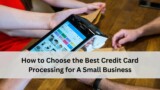 Close up of hands using a handheld point of sale terminal on a wooden counter, with a text banner that reads “How to Choose the Best Credit Card Processing for A Small Business.”