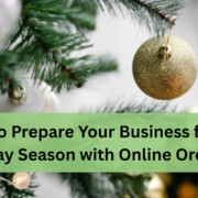A close up of a decorated Christmas tree with green branches and shiny ornaments, including a gold glittery bauble in focus