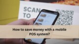 Hand holding a smartphone showing a mobile POS menu with food items, with a QR code sign in the background and the text “How to save money with a mobile POS system?”