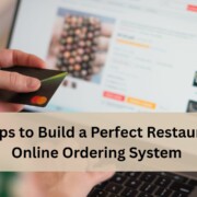 Person holding a credit card while using a laptop to place an online order, with the text “Steps to Build a Perfect Restaurant Online Ordering System”