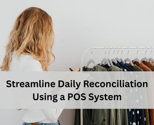 Employee reviewing clothing inventory on a rack and writing notes, representing using a POS system to streamline daily reconciliation.