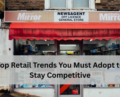 Front view of a small retail store with a red awning, newspaper signage, and various products visible through the windows