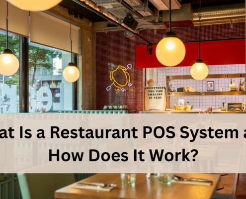 A bright modern restaurant interior with hanging globe lights, large windows, and a view of the street outside.