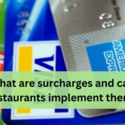 A close up view of several credit cards layered on top of each other, including MasterCard, Visa, and American Express.