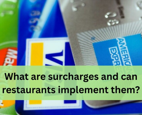 A close up view of several credit cards layered on top of each other, including MasterCard, Visa, and American Express.