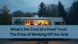 A food truck parked outdoors at dusk with warm light glowing from the service window. Two workers inside prepare food while customers stand outside placing orders.