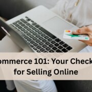 A person sitting on a couch using a laptop while holding a credit card in one hand, ready to make an online purchase