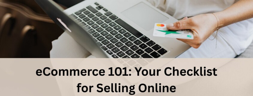 A person sitting on a couch using a laptop while holding a credit card in one hand, ready to make an online purchase